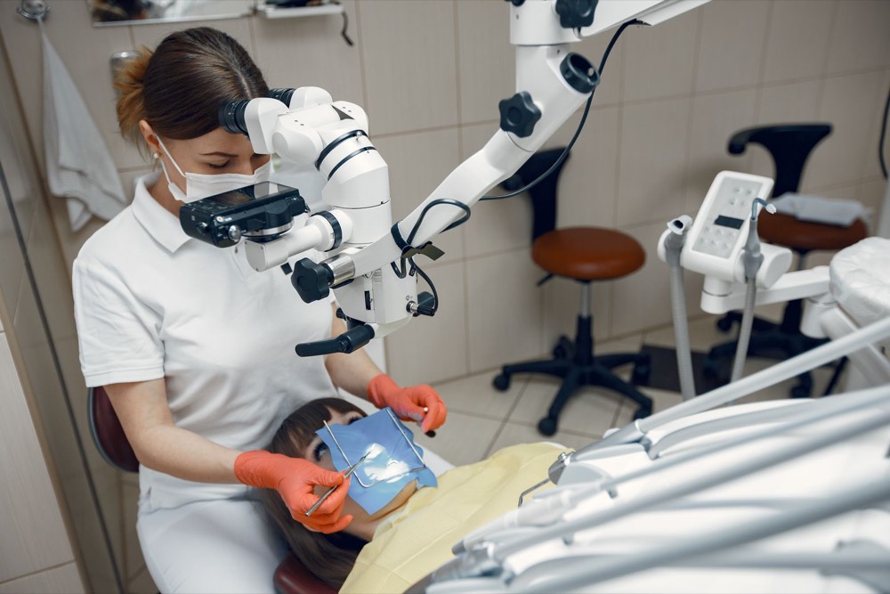 A dentist treating a patient in the chair